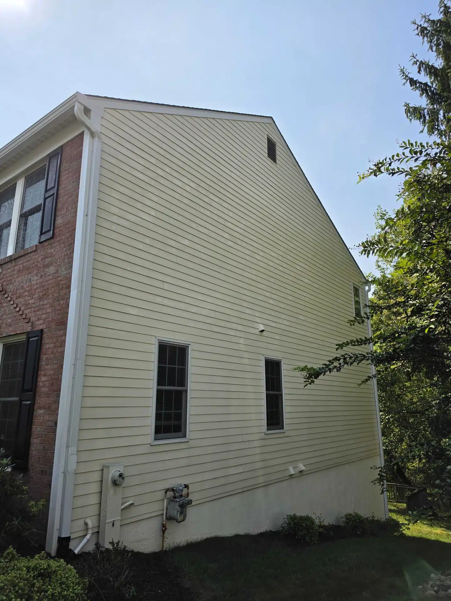 Two-story house siding after cleaning