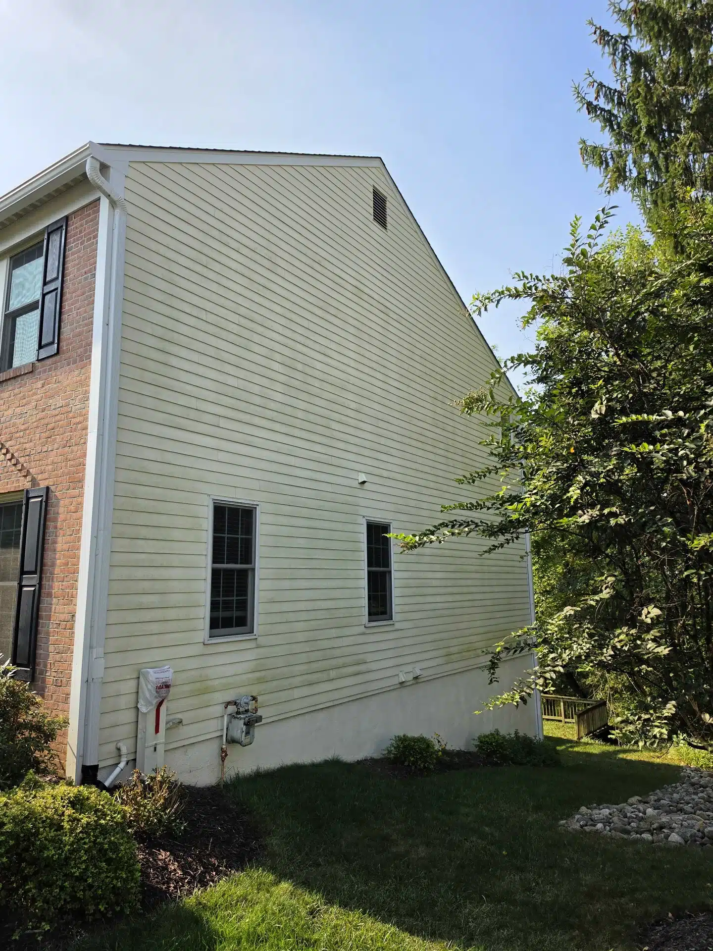 Two-story house siding before cleaning